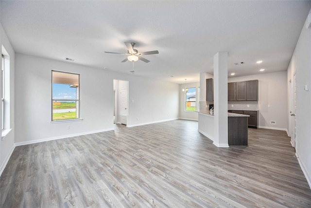 16853 Needlepoint Dr, Conroe, TX 77302 - unfurnished living room with a ceiling fan, light wood finished floors, and recessed lighting