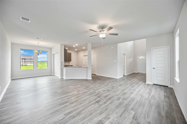 16853 Needlepoint Dr, Conroe, TX 77302 - unfurnished living room with light wood-type flooring, a ceiling fan, a chandelier, and recessed lighting