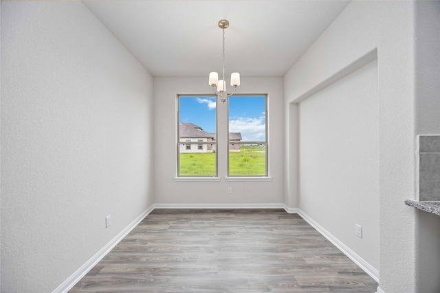 16853 Needlepoint Dr, Conroe, TX 77302 - unfurnished dining area featuring a chandelier and wood finished floors