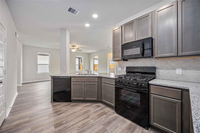 16853 Needlepoint Dr, Conroe, TX 77302 - kitchen with black appliances, light wood-type flooring, a peninsula, a ceiling fan, and recessed lighting