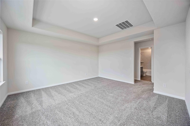16853 Needlepoint Dr, Conroe, TX 77302 - spare room with a tray ceiling, carpet floors, and recessed lighting