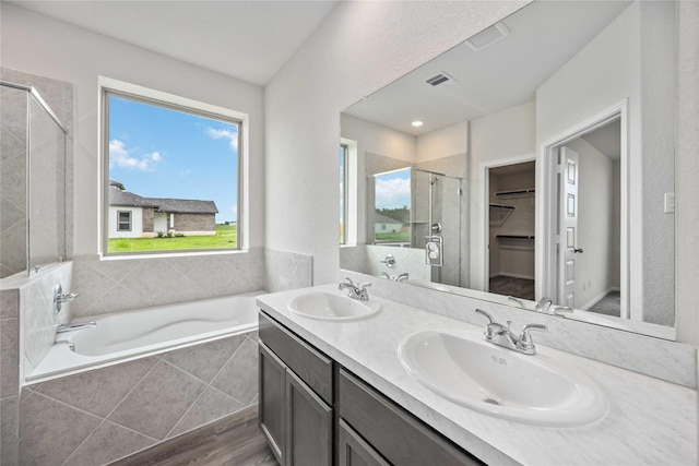 16853 Needlepoint Dr, Conroe, TX 77302 - full bath featuring a stall shower, a garden tub, double vanity, and a walk in closet