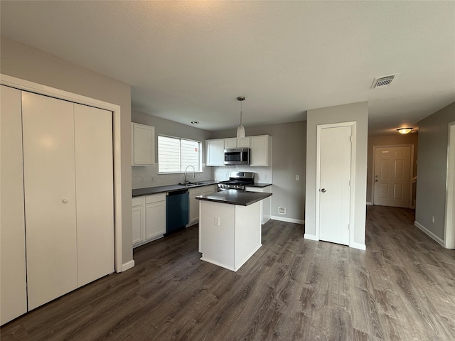 1091 Verde Trails Dr, Houston, TX 77073 - kitchen featuring stainless steel appliances, white cabinetry, and dark wood-style flooring