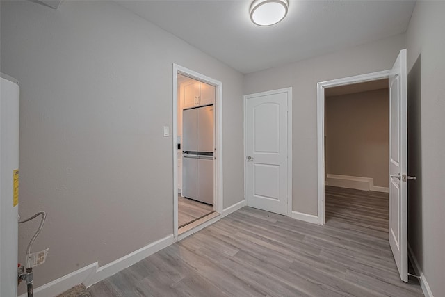 11502 Leader St, Houston, TX 77072 - unfurnished bedroom featuring high end refrigerator, light wood finished floors, and water heater
