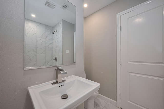 11502 Leader St, Houston, TX 77072 - bathroom featuring marble finish floors, a tile shower, and recessed lighting