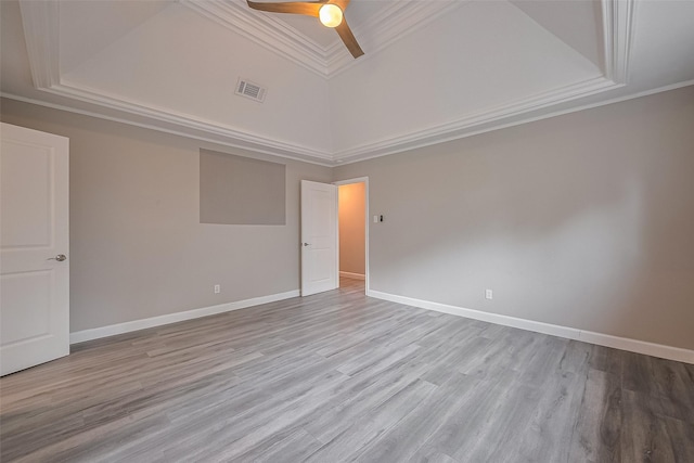 11502 Leader St, Houston, TX 77072 - spare room featuring a tray ceiling, ceiling fan, crown molding, wood finished floors, and a towering ceiling