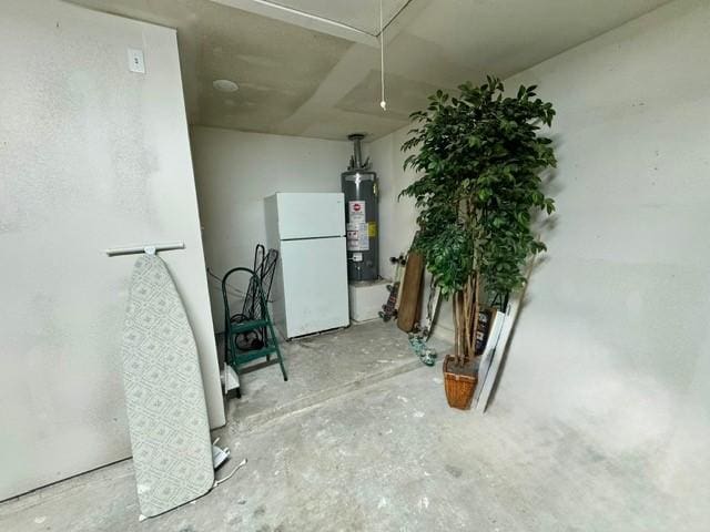 108 Audubon Woods Dr, Richwood, TX 77531 - basement featuring freestanding refrigerator and water heater