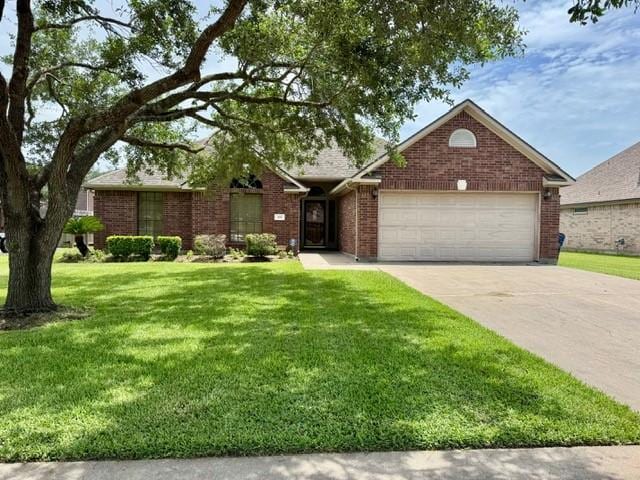 108 Audubon Woods Dr, Richwood, TX 77531 - view of front facade with a garage, concrete driveway, brick siding, and a front yard