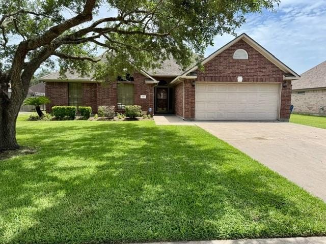 108 Audubon Woods Dr, Richwood, TX 77531 - single story home with an attached garage, concrete driveway, brick siding, and a front yard