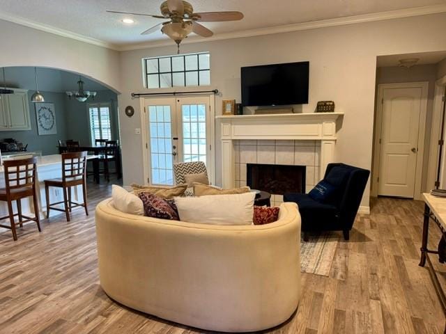 108 Audubon Woods Dr, Richwood, TX 77531 - living room with a ceiling fan, wood finished floors, french doors, ornamental molding, and a fireplace