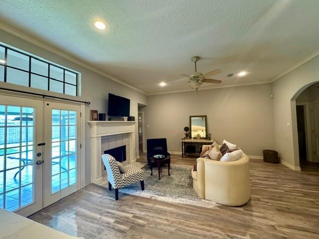 108 Audubon Woods Dr, Richwood, TX 77531 - living area with ornamental molding, wood finished floors, arched walkways, french doors, and healthy amount of natural light