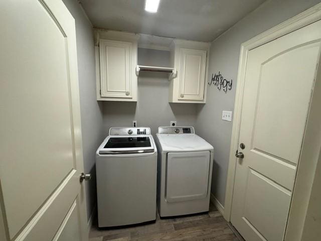 108 Audubon Woods Dr, Richwood, TX 77531 - laundry room with cabinet space, washing machine and clothes dryer, and wood finished floors