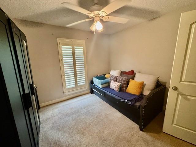 108 Audubon Woods Dr, Richwood, TX 77531 - bedroom with light carpet, a textured ceiling, and ceiling fan