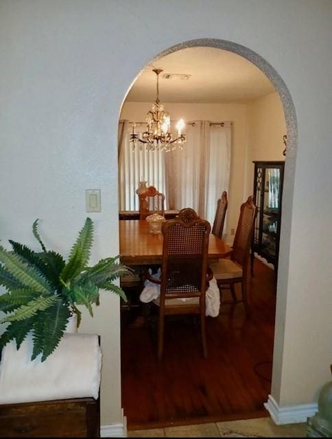 903 Happy Holw, Sweeny, TX 77480 - dining area featuring arched walkways and a chandelier