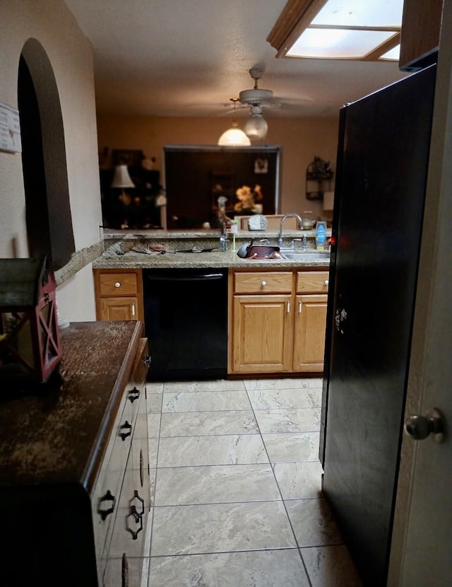 903 Happy Holw, Sweeny, TX 77480 - kitchen with black appliances, ceiling fan, dark stone counters, arched walkways, and a peninsula