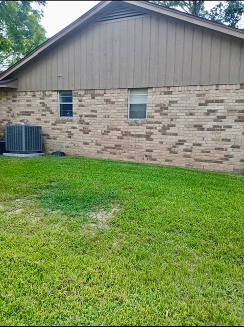 903 Happy Holw, Sweeny, TX 77480 - view of side of home with a lawn, brick siding, and board and batten siding