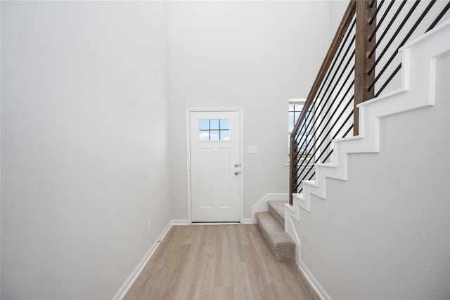 16866 Needlepoint Dr, Conroe, TX 77302 - entryway with light wood-style flooring, stairs, and a high ceiling