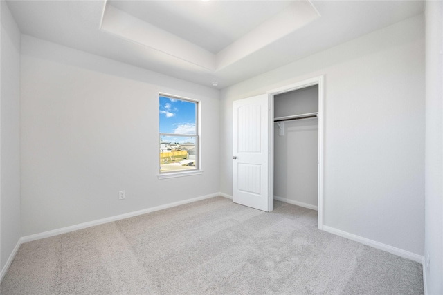 16866 Needlepoint Dr, Conroe, TX 77302 - unfurnished bedroom with carpet flooring, a raised ceiling, and a closet