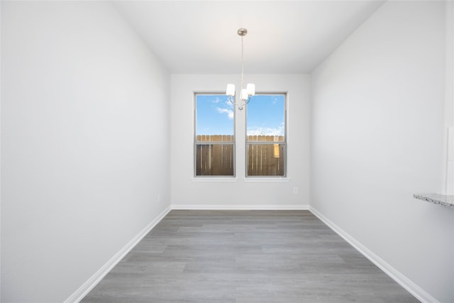 16866 Needlepoint Dr, Conroe, TX 77302 - empty room featuring a chandelier and wood finished floors
