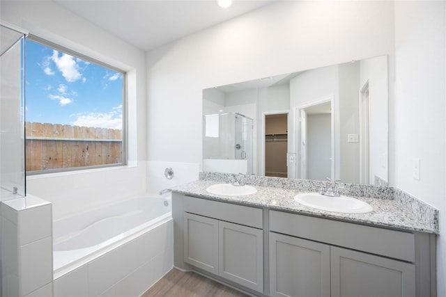 16866 Needlepoint Dr, Conroe, TX 77302 - bathroom with a bath, double vanity, a stall shower, and a walk in closet