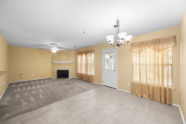 14319 Heron Marsh Dr, Cypress, TX 77429 - unfurnished living room featuring ceiling fan, a chandelier, and a fireplace