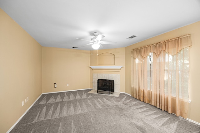 14319 Heron Marsh Dr, Cypress, TX 77429 - unfurnished living room with carpet, a tiled fireplace, and a ceiling fan