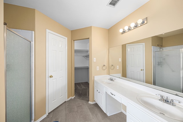 14319 Heron Marsh Dr, Cypress, TX 77429 - bathroom with a shower stall, double vanity, tile patterned flooring, and a spacious closet
