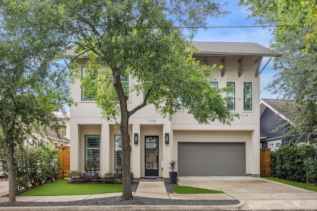 1116 W Drew St, Houston, TX 77006 - view of front of house with concrete driveway, an attached garage, and stucco siding