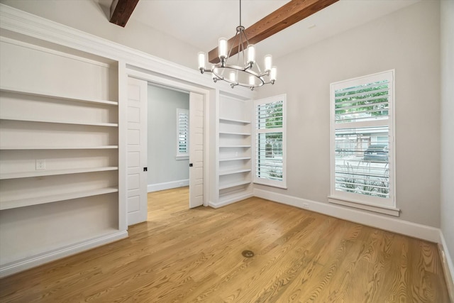 1116 W Drew St, Houston, TX 77006 - unfurnished dining area with built in shelves, beamed ceiling, a chandelier, and light wood-style flooring