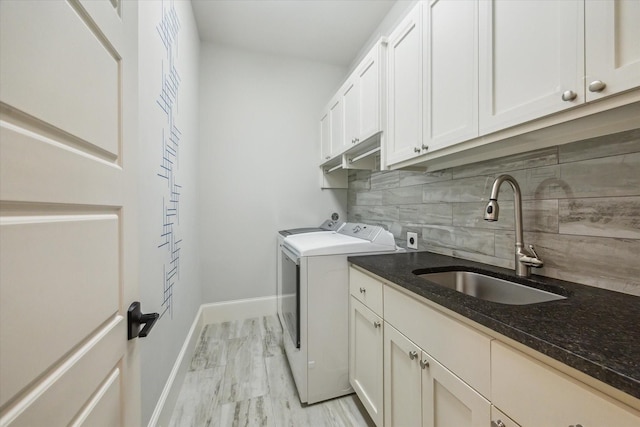 1116 W Drew St, Houston, TX 77006 - laundry room with cabinet space, washer and clothes dryer, and light marble finish flooring