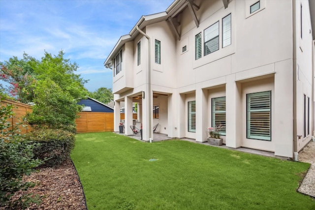 1116 W Drew St, Houston, TX 77006 - rear view of house featuring a fenced backyard, stucco siding, and a patio area