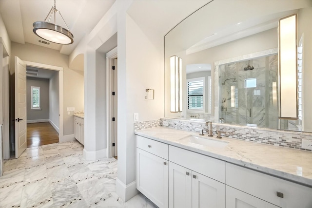 1116 W Drew St, Houston, TX 77006 - bathroom featuring a marble finish shower, vanity, and backsplash