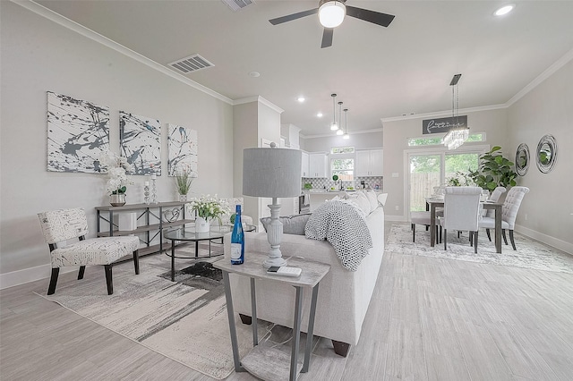 7108 Saint Augustine St, Houston, TX 77021 - living area featuring crown molding, a ceiling fan, light wood-type flooring, and recessed lighting