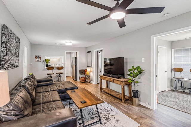 3318 Europa St, Houston, TX 77022 - living area with light wood-style floors and a ceiling fan