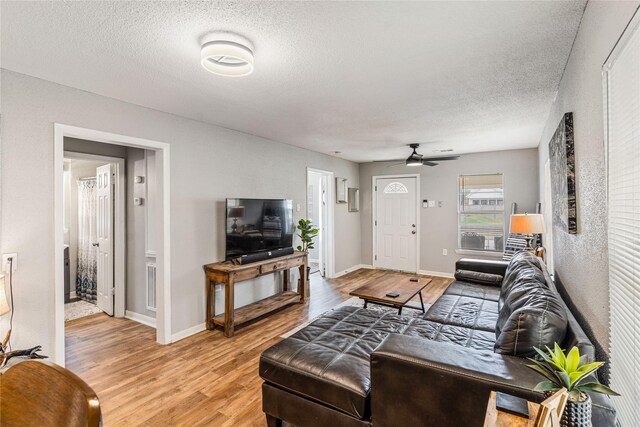 3318 Europa St, Houston, TX 77022 - living room with light wood-type flooring, a textured ceiling, and ceiling fan