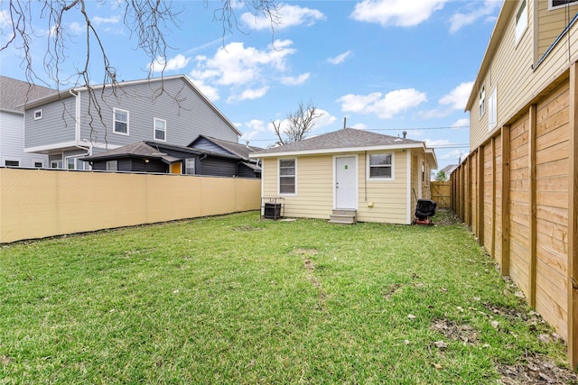 3318 Europa St, Houston, TX 77022 - back of house featuring a fenced backyard, an outdoor structure, and entry steps