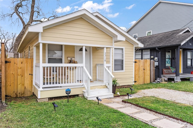 3318 Europa St, Houston, TX 77022 - shotgun-style home featuring a gate and covered porch