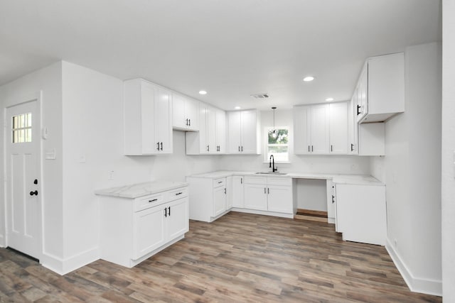 8221 Hezekiah Ln, Houston, TX 77088 - kitchen featuring recessed lighting, wood finished floors, white cabinets, and light stone countertops