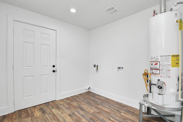 8221 Hezekiah Ln, Houston, TX 77088 - laundry area featuring gas water heater, hookup for an electric dryer, recessed lighting, hookup for a washing machine, and dark wood-style flooring