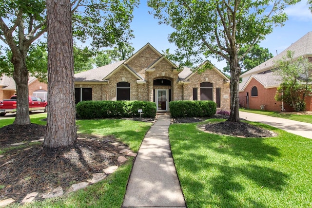 14510 Kings Head Dr, Houston, TX 77044 - traditional home with a front lawn, brick siding, and roof with shingles