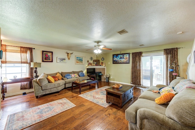 11734 Filaree Trl, Houston, TX 77044 - living room featuring a textured ceiling, a ceiling fan, plenty of natural light, and hardwood / wood-style flooring