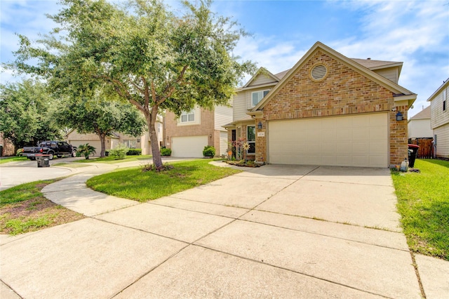 11734 Filaree Trl, Houston, TX 77044 - view of front facade with brick siding, concrete driveway, a front yard, and a garage