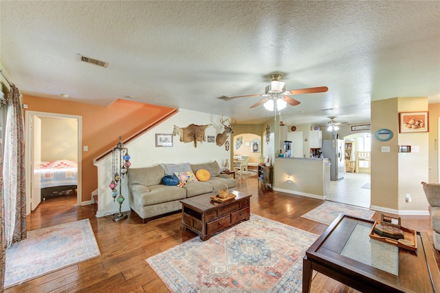 11734 Filaree Trl, Houston, TX 77044 - living room with a ceiling fan, wood finished floors, and a textured ceiling