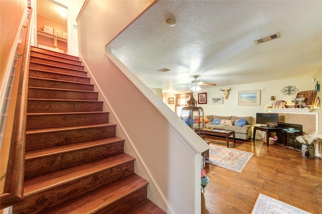 11734 Filaree Trl, Houston, TX 77044 - staircase featuring ceiling fan, hardwood / wood-style flooring, and a textured ceiling