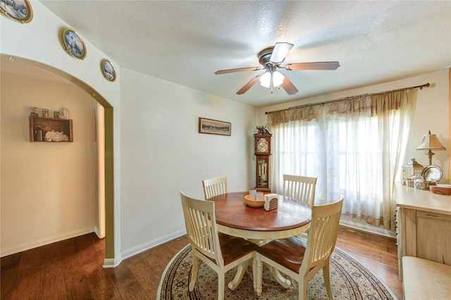11734 Filaree Trl, Houston, TX 77044 - dining space featuring ceiling fan, wood finished floors, arched walkways, and a textured ceiling