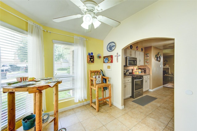 11734 Filaree Trl, Houston, TX 77044 - kitchen featuring stainless steel appliances, lofted ceiling, tasteful backsplash, light tile patterned flooring, and a ceiling fan