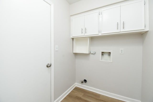 1010 Rock Canyon Dr, Katy, TX 77450 - laundry area with cabinet space, wood finished floors, washer hookup, and hookup for a gas dryer