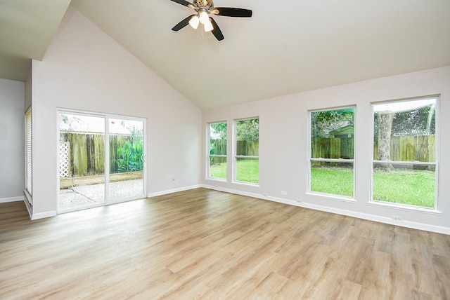 1010 Rock Canyon Dr, Katy, TX 77450 - empty room featuring plenty of natural light, a ceiling fan, high vaulted ceiling, and wood finished floors