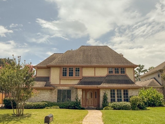 16627 Aldenham Pl, Spring, TX 77379 - view of front of home with a front lawn, brick siding, stucco siding, and roof with shingles
