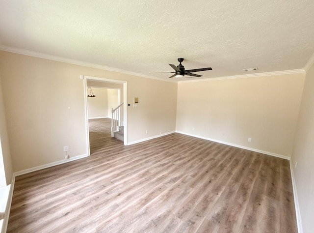 16627 Aldenham Pl, Spring, TX 77379 - spare room featuring wood finished floors, a textured ceiling, ornamental molding, and a ceiling fan